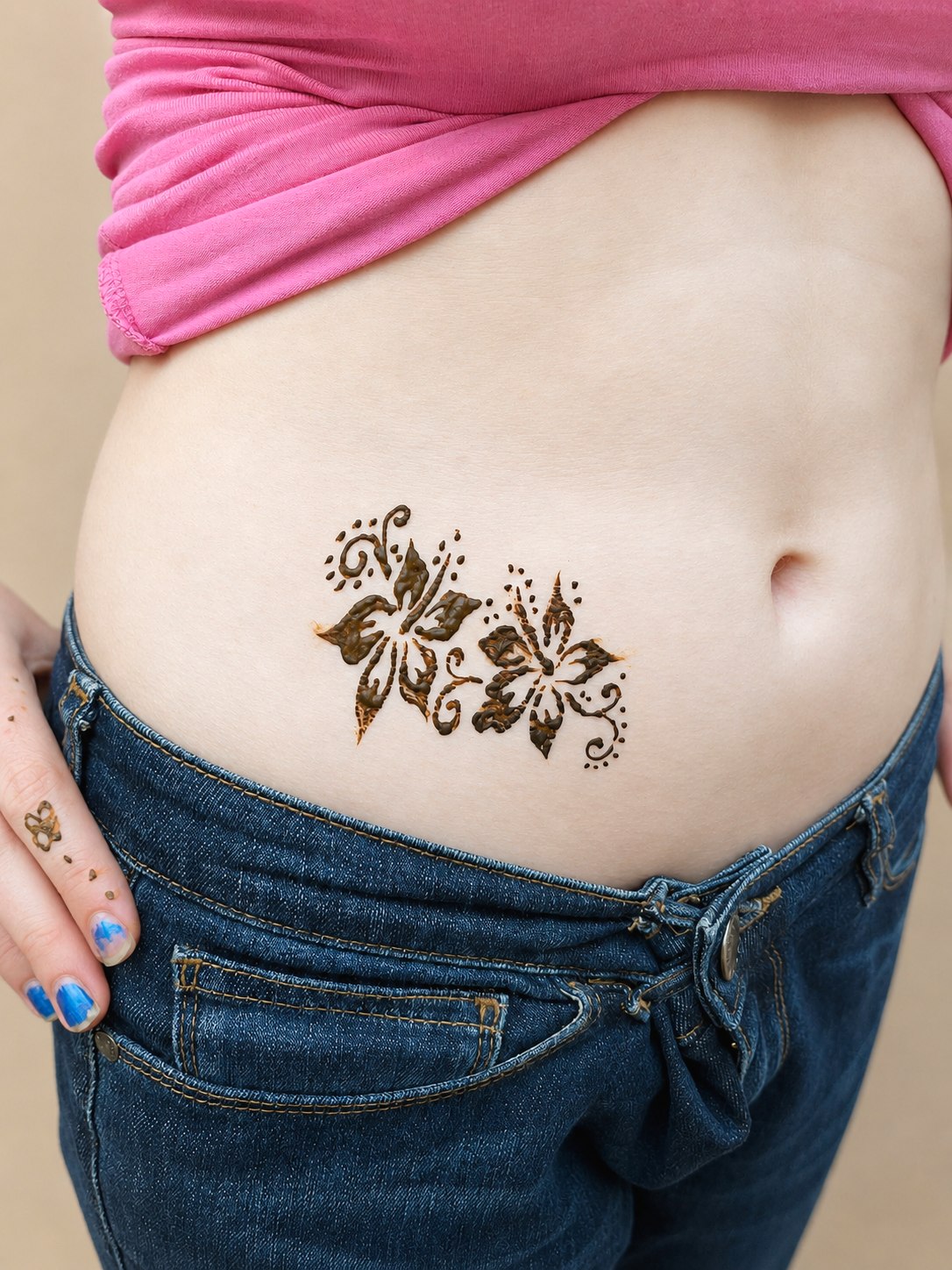 Two large hibiscus flowers henna design on tummy